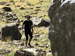 Tripper with rucksack and stick crossing a way of high mountain in the pyrenees, Gavarnie Tripper with rucksack and stick crossing a way of high mountain in the pyrenees, Gavarnie