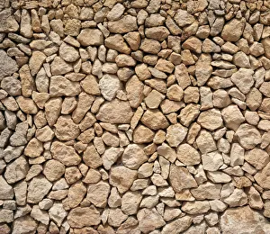 Typical Balearic dry stone wall made of yellow and red boulders Typical Balearic dry stone wall made of yellow and red boulders