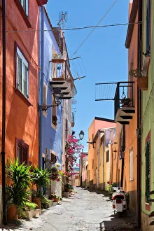 Uphill street with colourful architecture in Bosa, Sardinia, on a sunny day Uphill street with colourful architecture in Bosa, Sardinia, on a sunny day