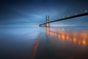 <b class=qtipBold><figcaption>Vasco da Gama bridge</figcaption></b><br>The Ponte Vasco da Gama Lisbon is a massive 17km long bridge that spans the shallow but wide Tagus Estuary to the east of Lisbon. This massive bridge was once Europe longest bridge and was named after Portugal great explorer Vasco da Gama.<br><em>© FredConcha</em> Vasco da Gama bridge