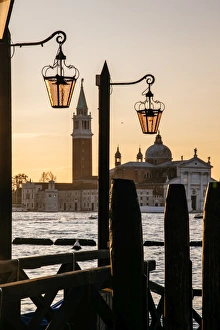 Venetian street lanterns with Church of San Giorgio Maggiore on the backround at sunrise Venetian street lanterns with Church of San Giorgio Maggiore on the backround at sunrise