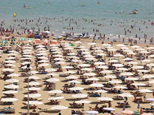 View of the beach with parasols, sun loungers and bathers, Lignano Sabbiadoro, Udine View of the beach with parasols, sun loungers and bathers, Lignano Sabbiadoro, Udine