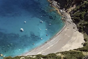 View on the beach Platja des Coll Baix, turquoise blue water, anchoring boats, peninsula View on the beach Platja des Coll Baix, turquoise blue water, anchoring boats, peninsula