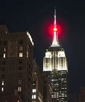 View of the top of the empire state Buildin at night in Manhattan, New York City View of the top of the empire state Buildin at night in Manhattan, New York City