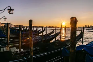 View on gondola station near Piazza San Marco with rising sun on the background View on gondola station near Piazza San Marco with rising sun on the background