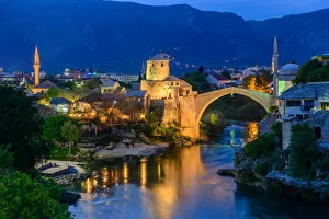 <b class=qtipBold><figcaption>View of Mostar old town</figcaption></b><br>Mostar old town is a city and municipality in southern Bosnia and Herzegovina. It is the most important city in the Herzegovina region, its cultural capital, and the center of the Herzegovina-Neretva Canton of the Federation. Mostar is situated on the Neretva River. This picture was taken during the twilight time on April 14, 2017 View of Mostar old town