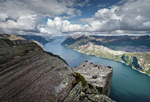 <b class=qtipBold><figcaption>View of Pulpit Rock, Norway</figcaption></b><br>Preikestolen, Pulpit Rock, in Norway. People at the edge of the rock. Deep below is Lysefjorden.<br><em>© Svein Nordrum</em> View of Pulpit Rock, Norway