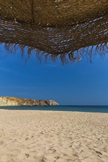View from underneath a parasol out onto the beach, Praia da Mareta, Sagres, Algarve View from underneath a parasol out onto the beach, Praia da Mareta, Sagres, Algarve