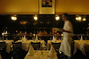 Waiter walking through restaurant, blurred motion Waiter walking through restaurant, blurred motion
