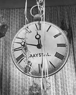 Oversize Gallery: Wall clock covered in party streamers, (B&W)