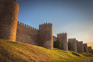 Walls of Avila at sunset. Fortified building. Fence surrounding the city Walls of Avila at sunset. Fortified building. Fence surrounding the city