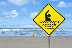 Warning sign strong currents, on a beach, Muriwai Beach, West Coast, Auckland, Auckland Region, New Zealand Warning sign strong currents, on a beach, Muriwai Beach, West Coast, Auckland, Auckland Region, New Zealand