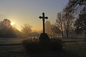 Wayside cross near a pond, early morning with sunrise, district of Mittelberg, Biberach Wayside cross near a pond, early morning with sunrise, district of Mittelberg, Biberach