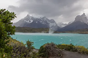 The wind whips up waves and a waterspout across the cold waters of Lake Pehue to the The wind whips up waves and a waterspout across the cold waters of Lake Pehue to the