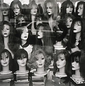 Window display of mannequin heads wearing assorted wigs Window display of mannequin heads wearing assorted wigs