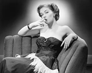 Woman in evening dress smoking cigarette (B&W), portrait Woman in evening dress smoking cigarette (B&W), portrait