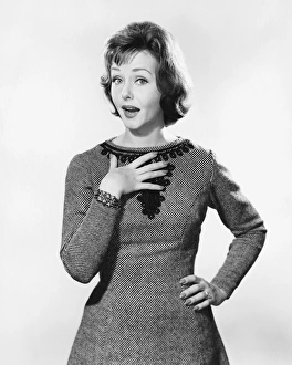 Woman with one hand on chest, other on hip, looking surprised Woman with one hand on chest, other on hip, looking surprised