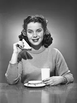 Woman having sandwich and milk, (B&W), portrait Woman having sandwich and milk, (B&W), portrait