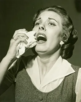 Woman holding handkerchief about to sneeze, (B&W), close-up Woman holding handkerchief about to sneeze, (B&W), close-up