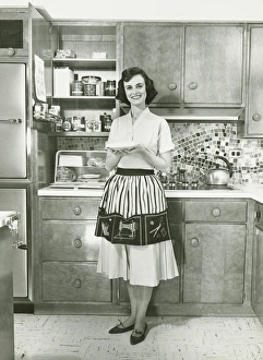 Woman holding pie, posing in kitchen, (B&W), portrait Woman holding pie, posing in kitchen, (B&W), portrait