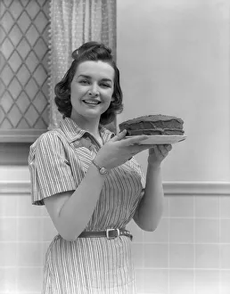 Woman (Mother, Wife) Holding Cake In Kitchen Woman (Mother, Wife) Holding Cake In Kitchen