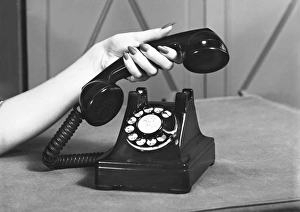 Woman picking up phone, (close up of hand), (B&W) Woman picking up phone, (close up of hand), (B&W)