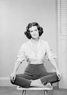 Bobbed Hair Gallery: Woman sitting crosslegged on chair, portrait