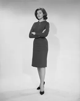 Bobbed Hair Gallery: Woman standing with arms crossed, studio shot