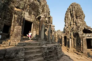 Woman standing in stone doorway of Bayon Temple Woman standing in stone doorway of Bayon Temple