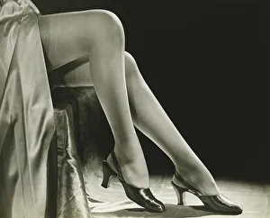 Woman in stockings sitting on chair, close-up of legs, (B&W), low section Woman in stockings sitting on chair, close-up of legs, (B&W), low section