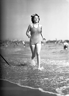 Woman in swimsuit running on shoreline, (B&W) Woman in swimsuit running on shoreline, (B&W)