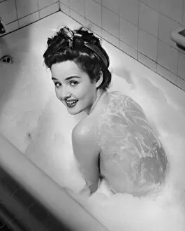 Images Dated 10th January 2007: Woman taking bubble bath, (B&W), elevated view