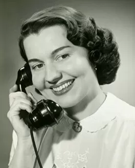 Bobbed Hair Gallery: Woman talking on phone, close-up, studio shot