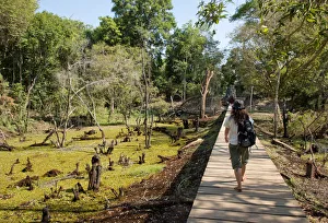 Woman on walkway at Neak Pean, Angkor, Cambodia Woman on walkway at Neak Pean, Angkor, Cambodia