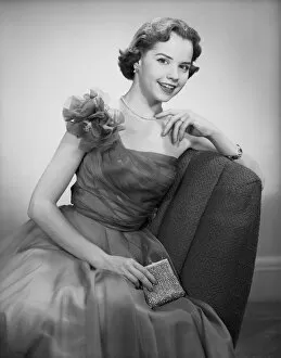 Bobbed Hair Gallery: Woman wearing dress sitting in chair, portrait