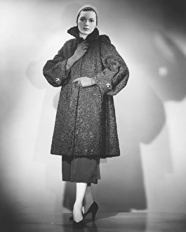 Woman wearing fur coat posing in studio (B&W) Woman wearing fur coat posing in studio (B&W)