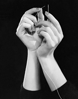 <b class=qtipBold><figcaption>Woman's hands threading needle</figcaption></b><br>UNITED STATES - CIRCA 1950s: Woman's hands threading needle.<br><em>© George Marks</em> Woman's hands threading needle
