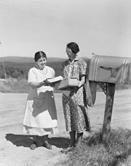 Images Dated 10th February 2006: Two women collect mail from country mailbox