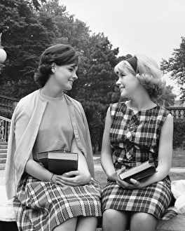Two women sitting on school campus, talking Two women sitting on school campus, talking