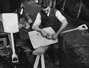 <b class=qtipBold><figcaption>Wood Carving</figcaption></b><br>circa 1930: A craftsman carves what appears to be a wooden shovel. (Photo by Hulton Archive/Getty Images) Wood Carving