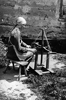 <b class=qtipBold><figcaption>Wool Winder</figcaption></b><br>circa 1907: A Latvian girl working at a wool winder. (Photo by Hulton Archive/Getty Images) Wool Winder