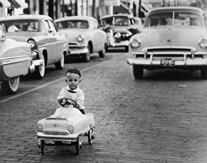 <b class=qtipBold><figcaption>Never Too Young</figcaption></b><br>A little boy takes his toy car for a spin on a real road, 1929. (Photo by FPG/Hulton Archive/Getty Images)<br><em>© 2005 Getty Images</em> Never Too Young