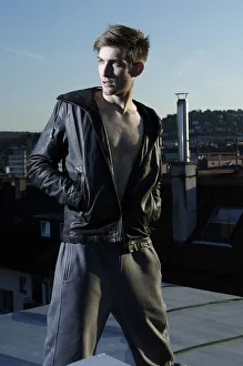 Young rebel in cool clothes on a roof at dusk Young rebel in cool clothes on a roof at dusk