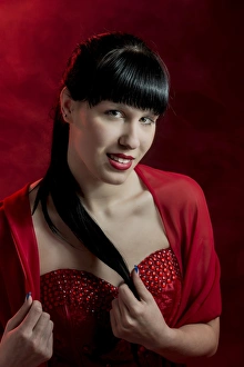 Young woman with long black hair in a red dress, portrait Young woman with long black hair in a red dress, portrait