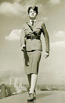 Young woman in military outfit marching on rooftop, portrait Young woman in military outfit marching on rooftop, portrait