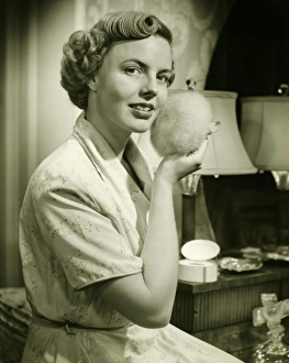 Young woman powdering face, at home, (B&W), portrait Young woman powdering face, at home, (B&W), portrait
