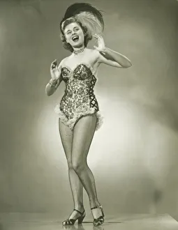 Young woman singing, posing in studio, (B&W) Young woman singing, posing in studio, (B&W)