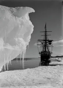 Antarctic Expedition Prints: Print of The Terra Nova ship at an ice-foot with a berg in the foreground