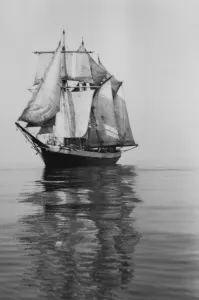 Penola at sea with sails set, reflections in foreground Penola at sea with sails set, reflections in foreground