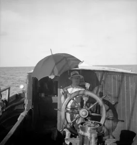 Quintin Riley at helm under umbrella Quintin Riley at helm under umbrella